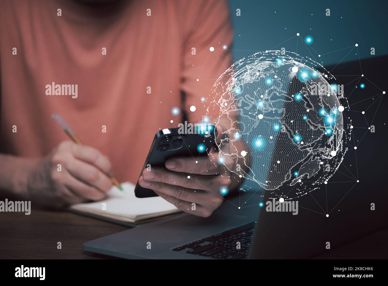 E learning concept. Casual business man studying online course via laptop computer and writing on notebook. Stock Photo