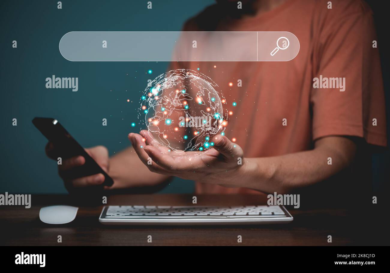 Searching online internet concept. Hand hold the earth with earth map and Mobile phone, online internet searching bar address in virtual screen. Onlin Stock Photo