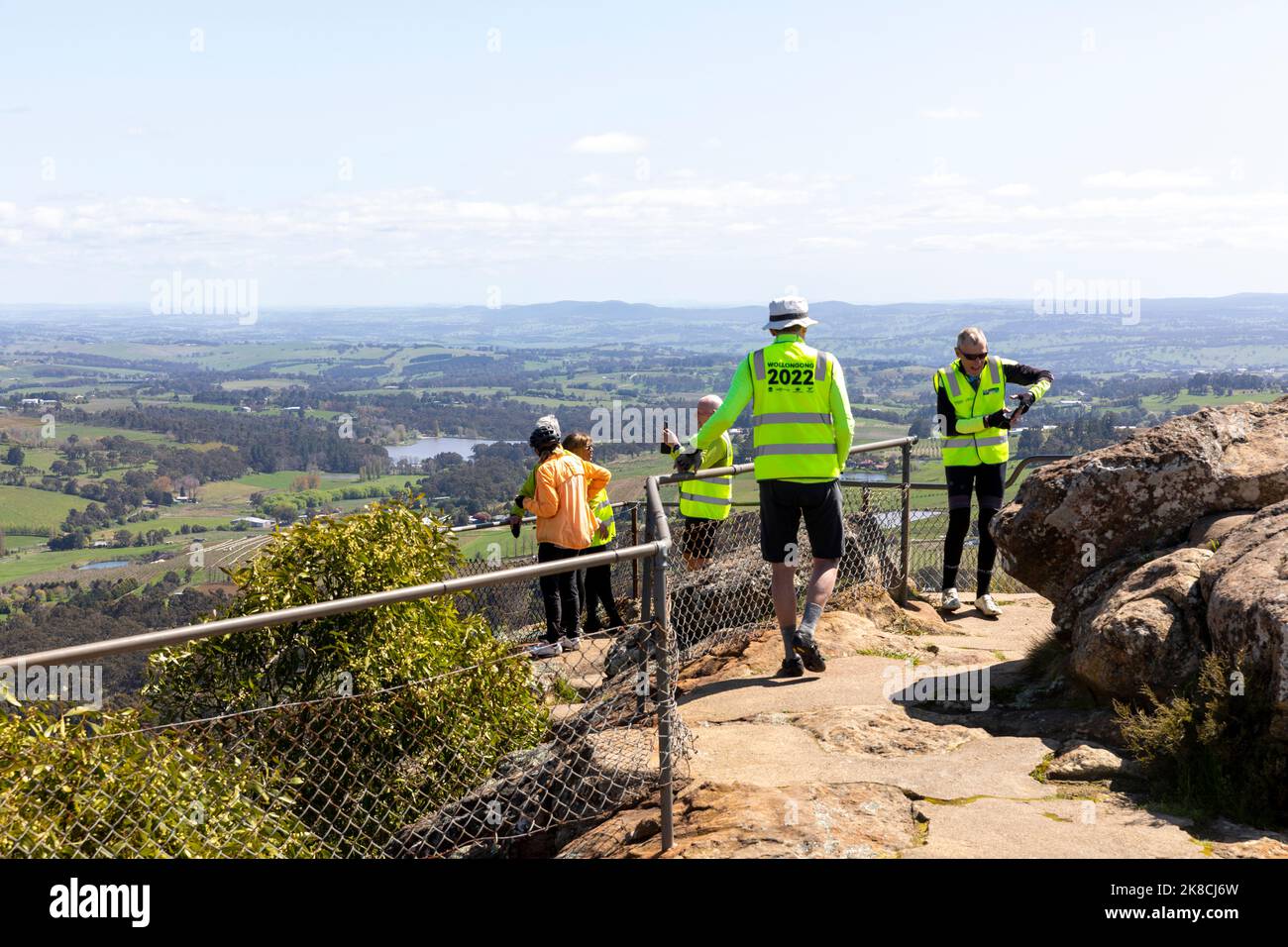 View from Towac pinnacle lookout in Orange NSW, male friends in senior years wearing cycling clothes at the summit,NSW,Australia Stock Photo