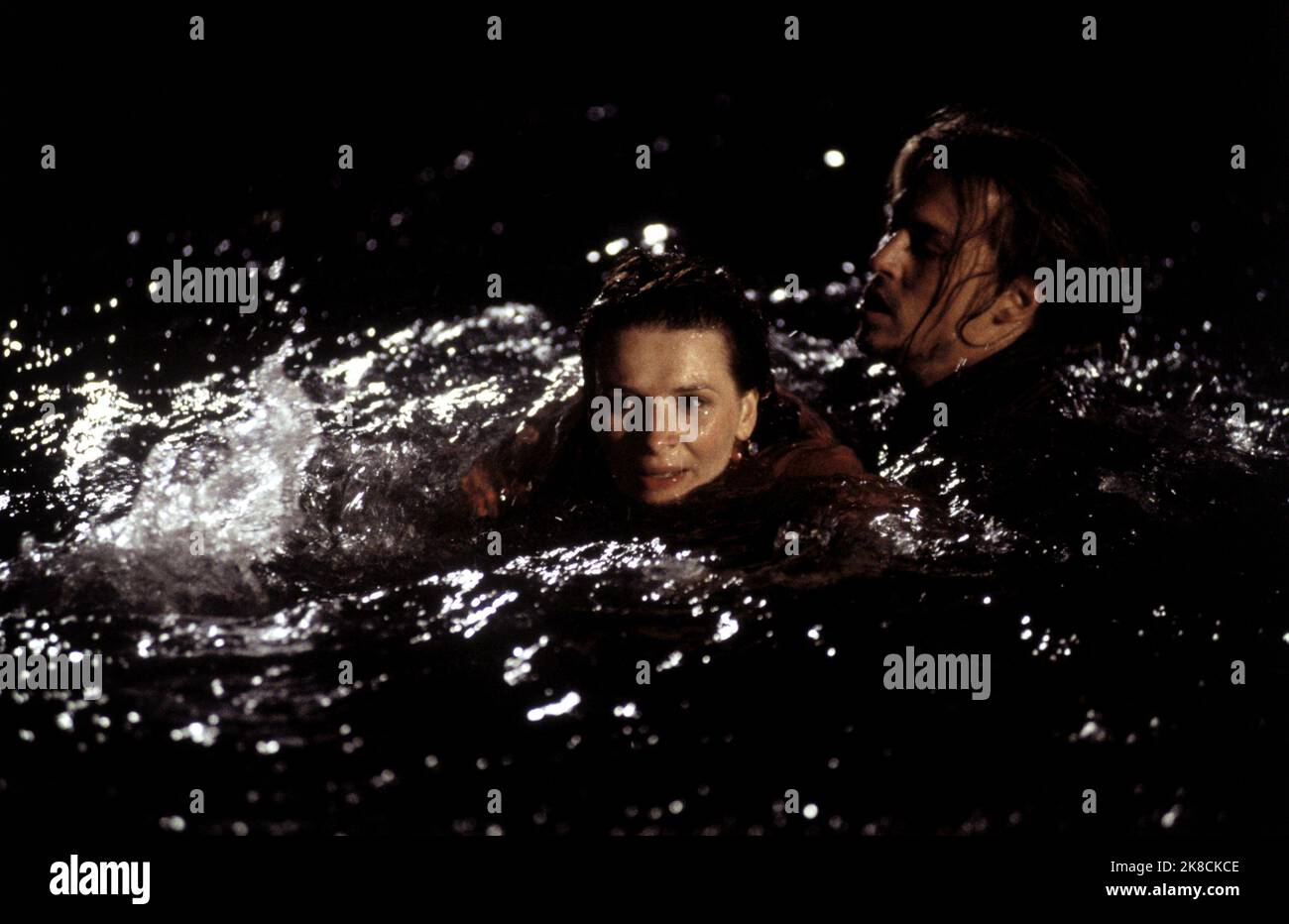 Juliette Binoche & Johnny Depp Film: Chocolat (USA/UK 2000) Characters: Vianne Rocher, Roux  Director: Lasse Hallström 15 December 2000   **WARNING** This Photograph is for editorial use only and is the copyright of DAVID BROWN PRODUCTIONS and/or the Photographer assigned by the Film or Production Company and can only be reproduced by publications in conjunction with the promotion of the above Film. A Mandatory Credit To DAVID BROWN PRODUCTIONS is required. The Photographer should also be credited when known. No commercial use can be granted without written authority from the Film Company. Stock Photo