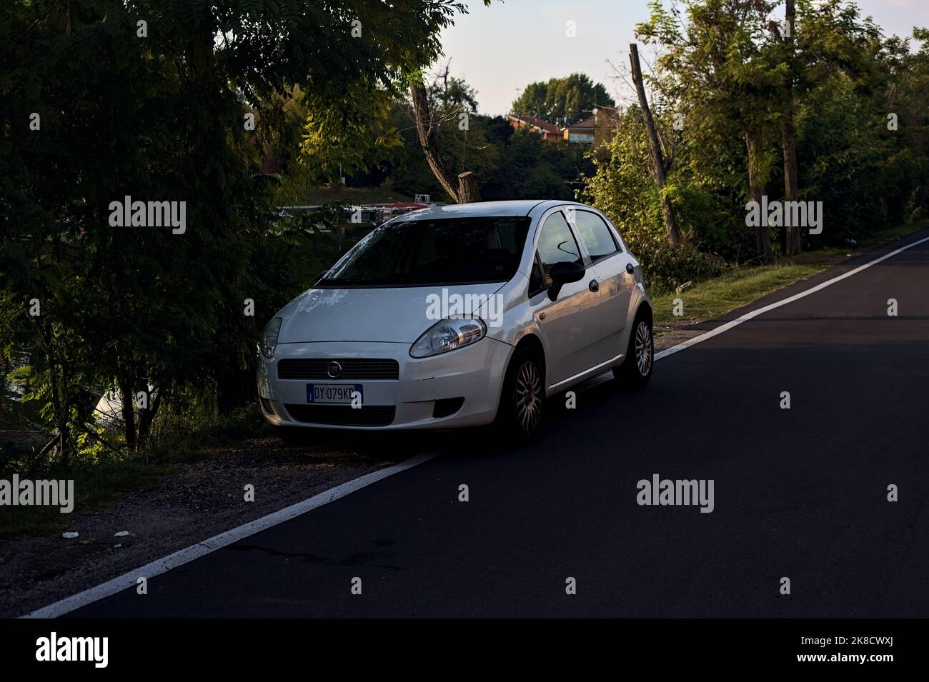 White  Fiat Punto by the lakeshore at sunset Stock Photo