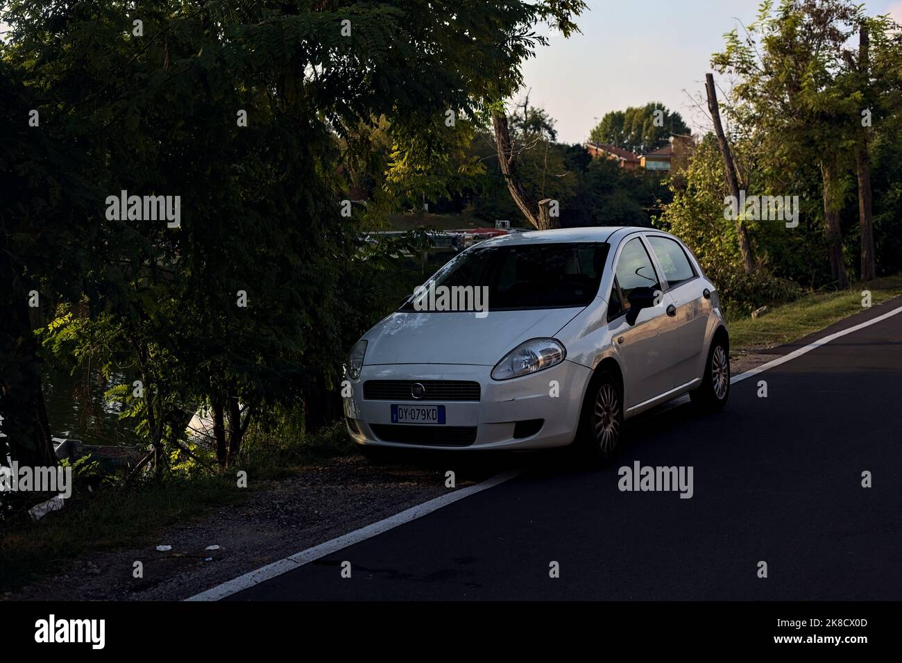 White  Fiat Punto by the lakeshore at sunset Stock Photo