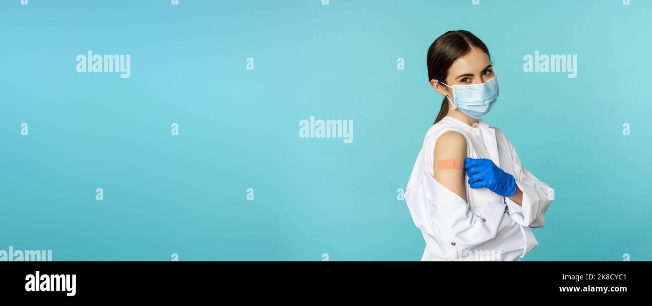 Young female doctor, nurse in medical face mask and hospital uniform ...