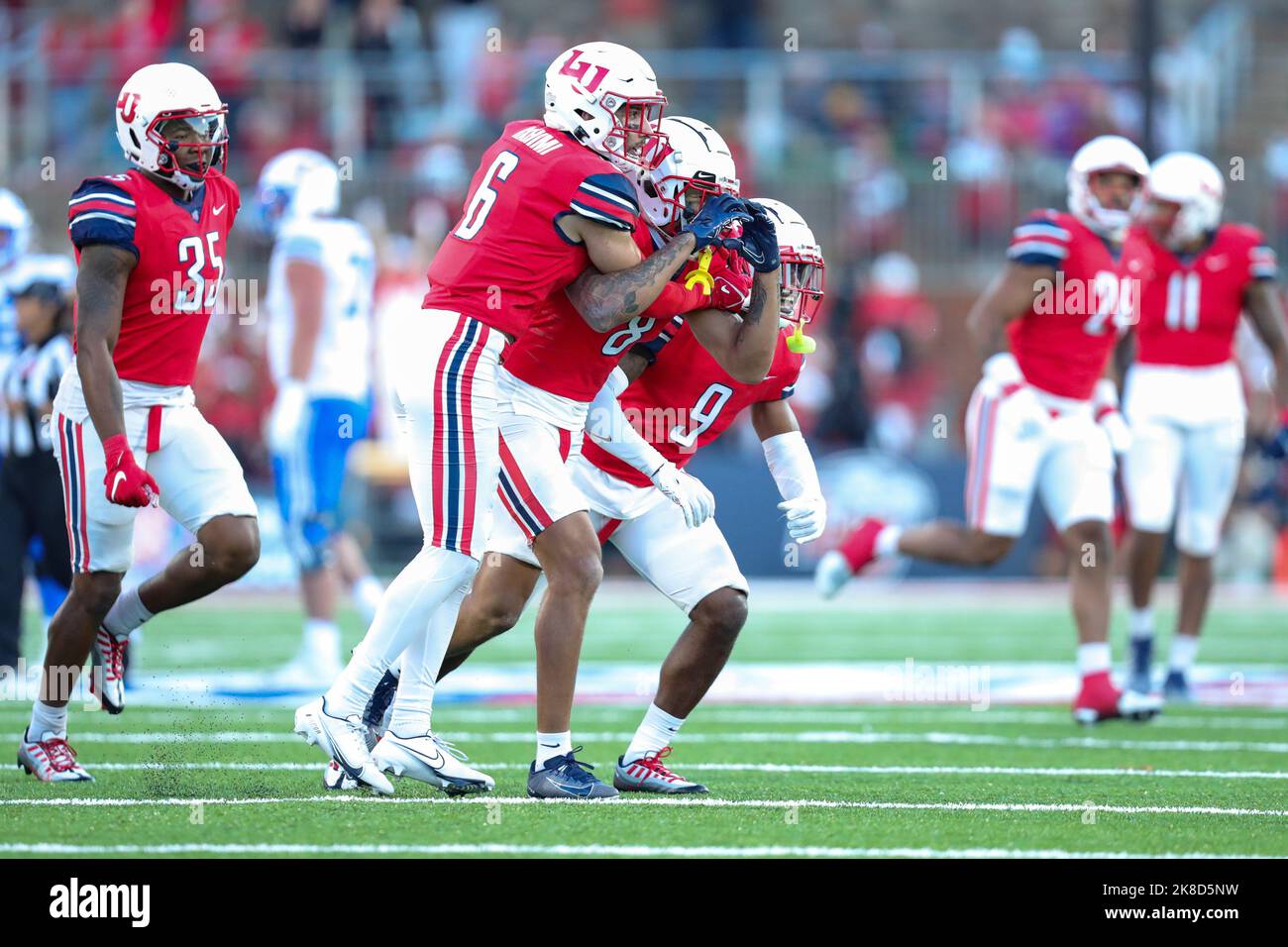 Lynchburg, Virginia, USA. 22nd Oct, 2022. Liberty Flames cornerback Daijahn Anthony (8) celebrates with safety Robert Rahimi (6) and safety Juawan Treadwell (9) during the NCAA football game between the Brigham Young Cougars and the Liberty Flames at Williams Stadium in Lynchburg, Virginia. Greg Atkins/CSM/Alamy Live News Stock Photo