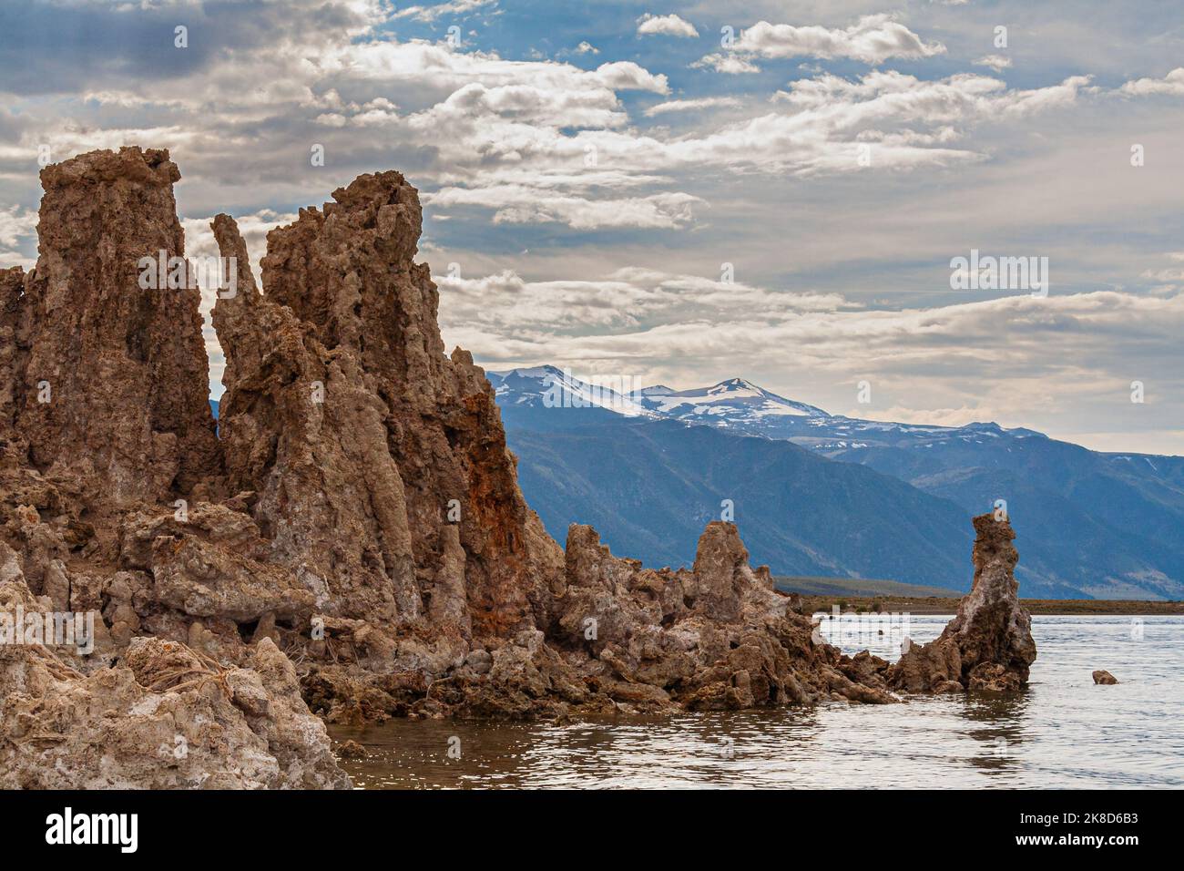 The Sierra Nevada mountains are framed by the tufa towers of Mono Lake. California. Stock Photo
