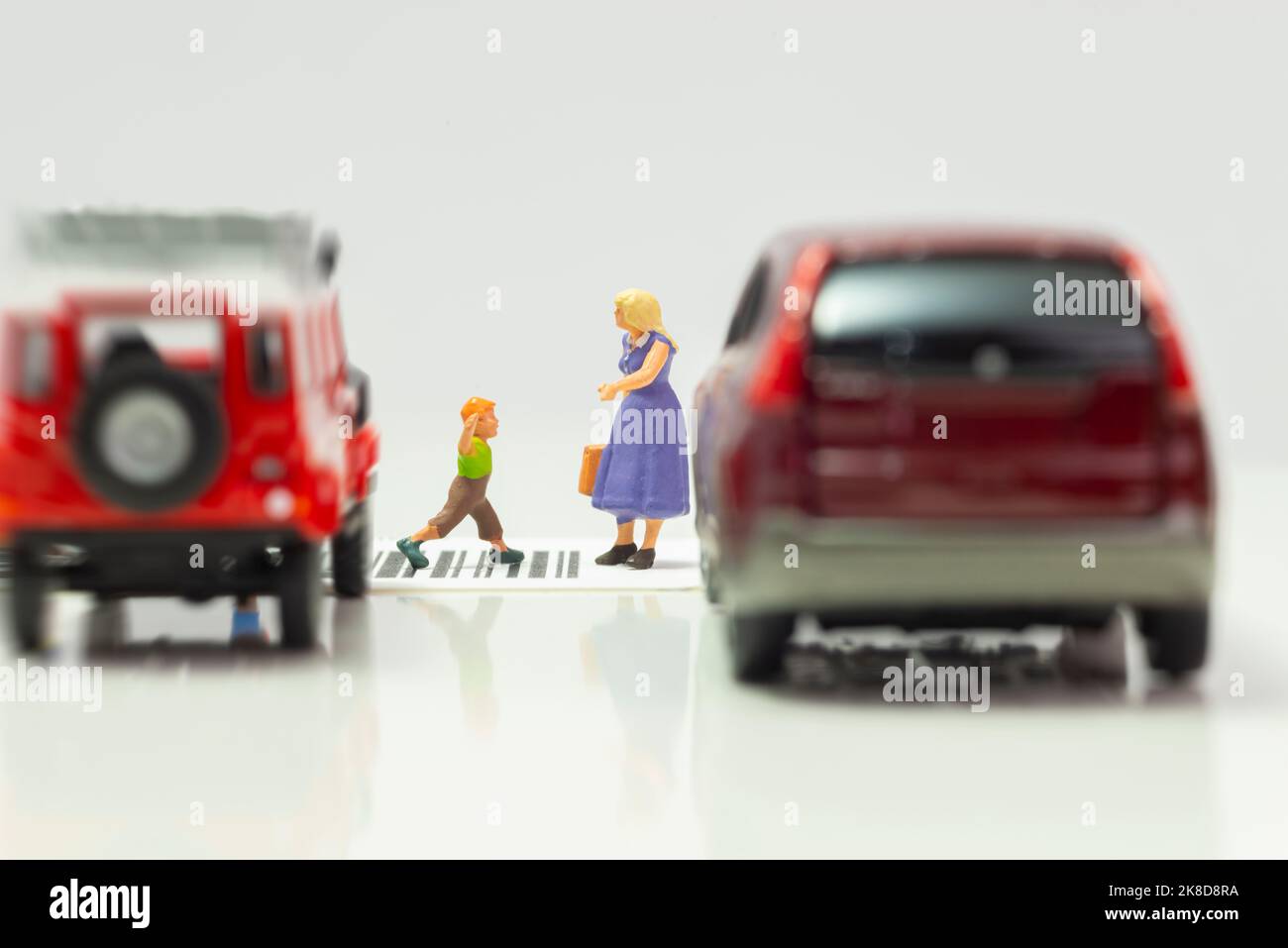 Miniature toys school kids walk on cross road bar code school