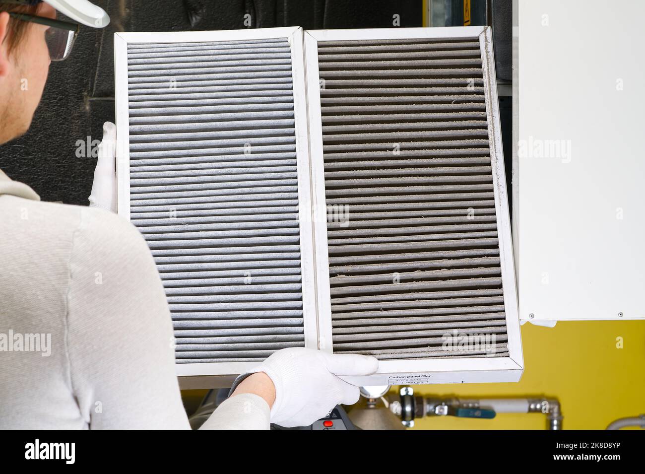 Replacing filter in the central ventilation system. hvac filter replacing home central air system Stock Photo