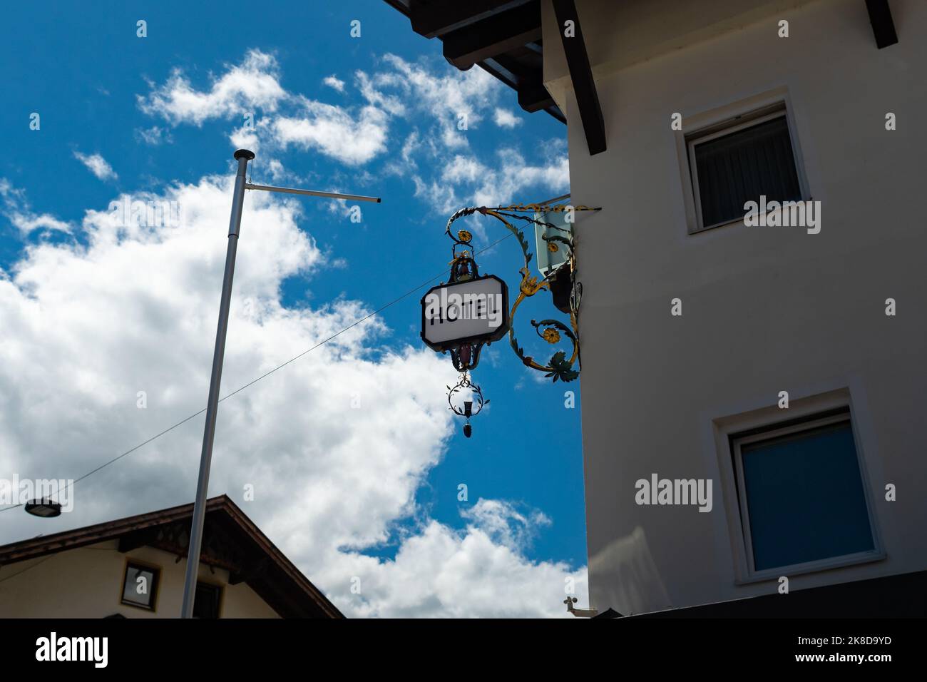 Vintage hotel sign on a building facade. Old forged steel frame in a beautiful design. Travelling in Tirol and seeing architectural features. Stock Photo