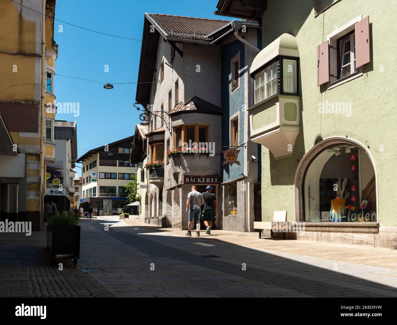 Street view in a town in Tirol with small businesses in the pedestrian zone. The beautiful Austrian architecture is a travel destination in Europe. Stock Photo