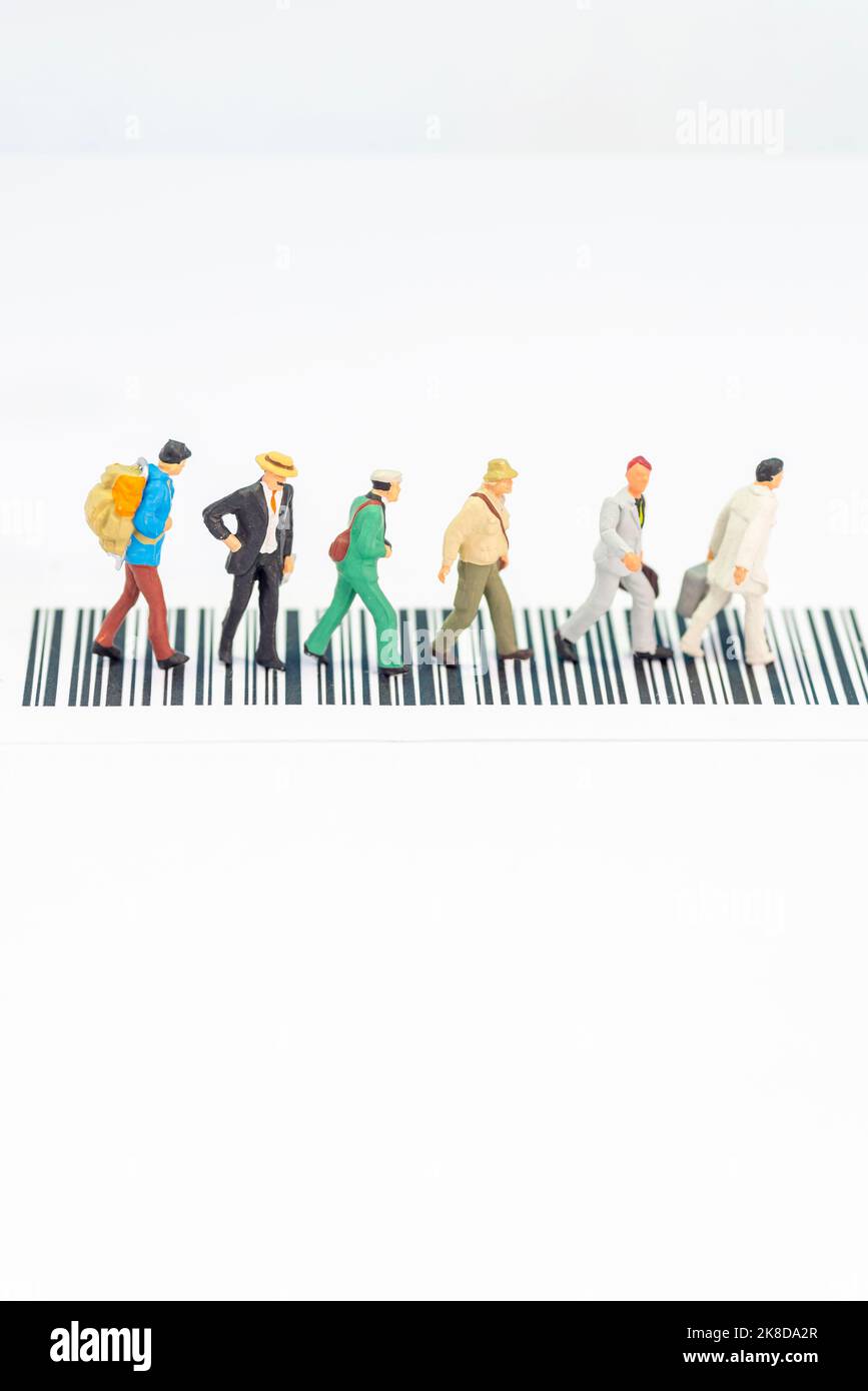 Miniature toys a group of people crossing a road - road safety concept. Stock Photo