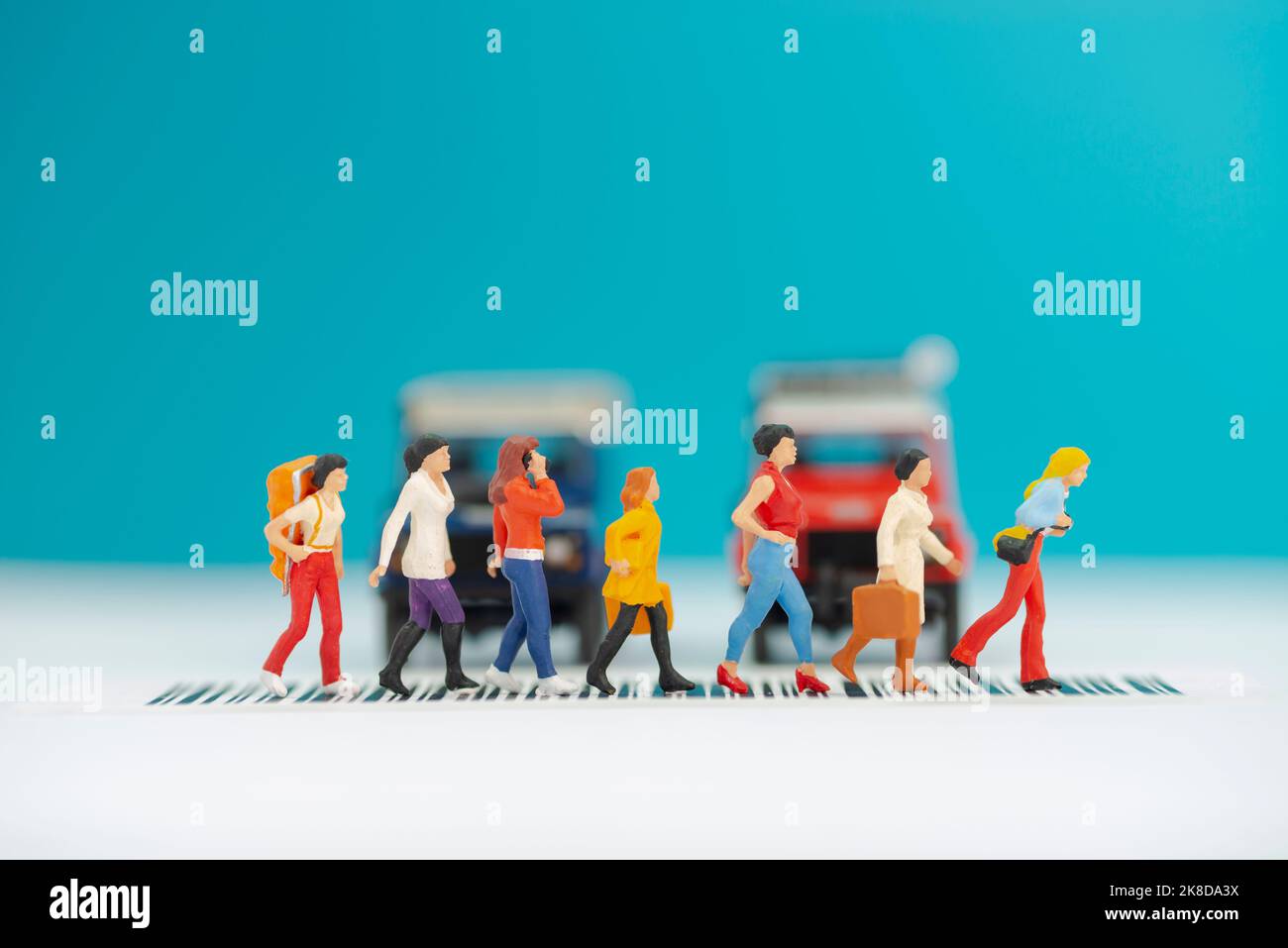 Miniature toys a group of women crossing a road - road safety concept. Stock Photo
