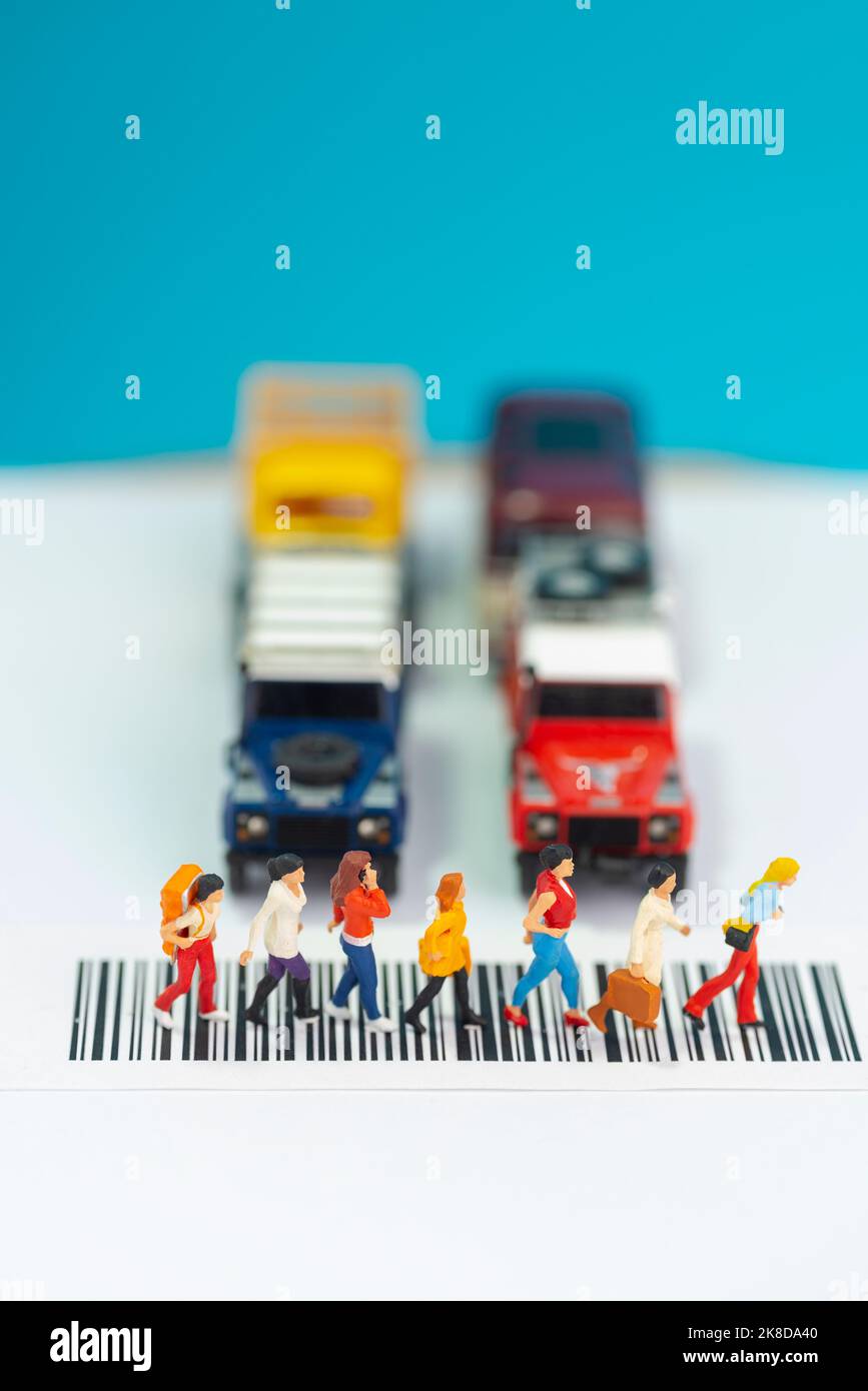 Miniature toys a group of women crossing a road - road safety concept. Stock Photo