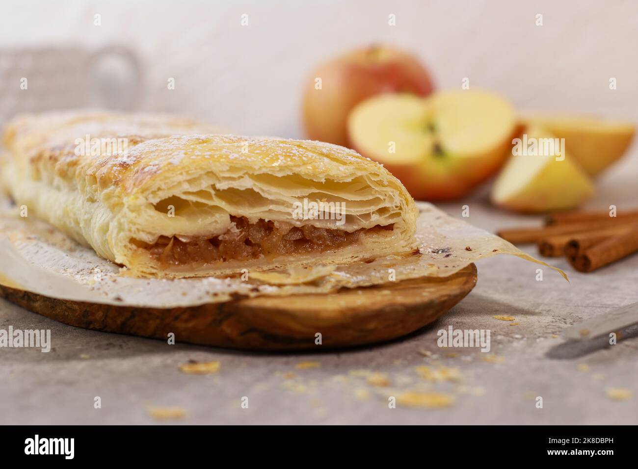 apple pastry strudel roll with cinnamon on grey marble table Stock Photo
