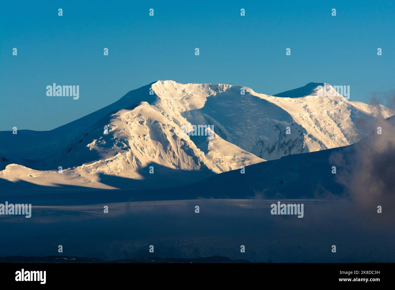 early morning sun lights up mt. francois (r). anvers island. antarctic