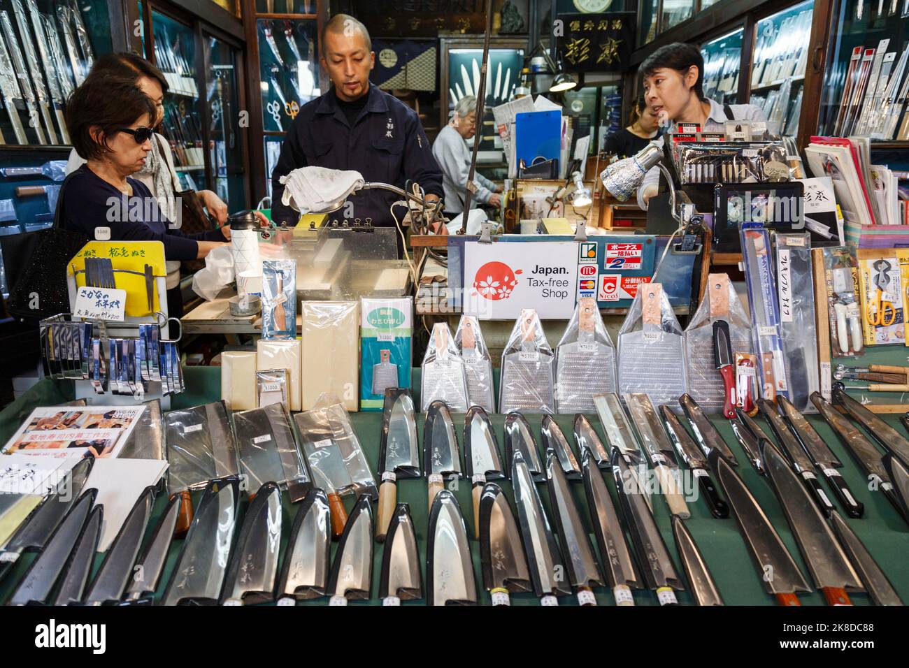Tokyo, Japan - October 26, 2022 : asian women are buy Japanese high quality traditional kitchen knifes at the local knives shop in Tokyo, Japan. Stock Photo