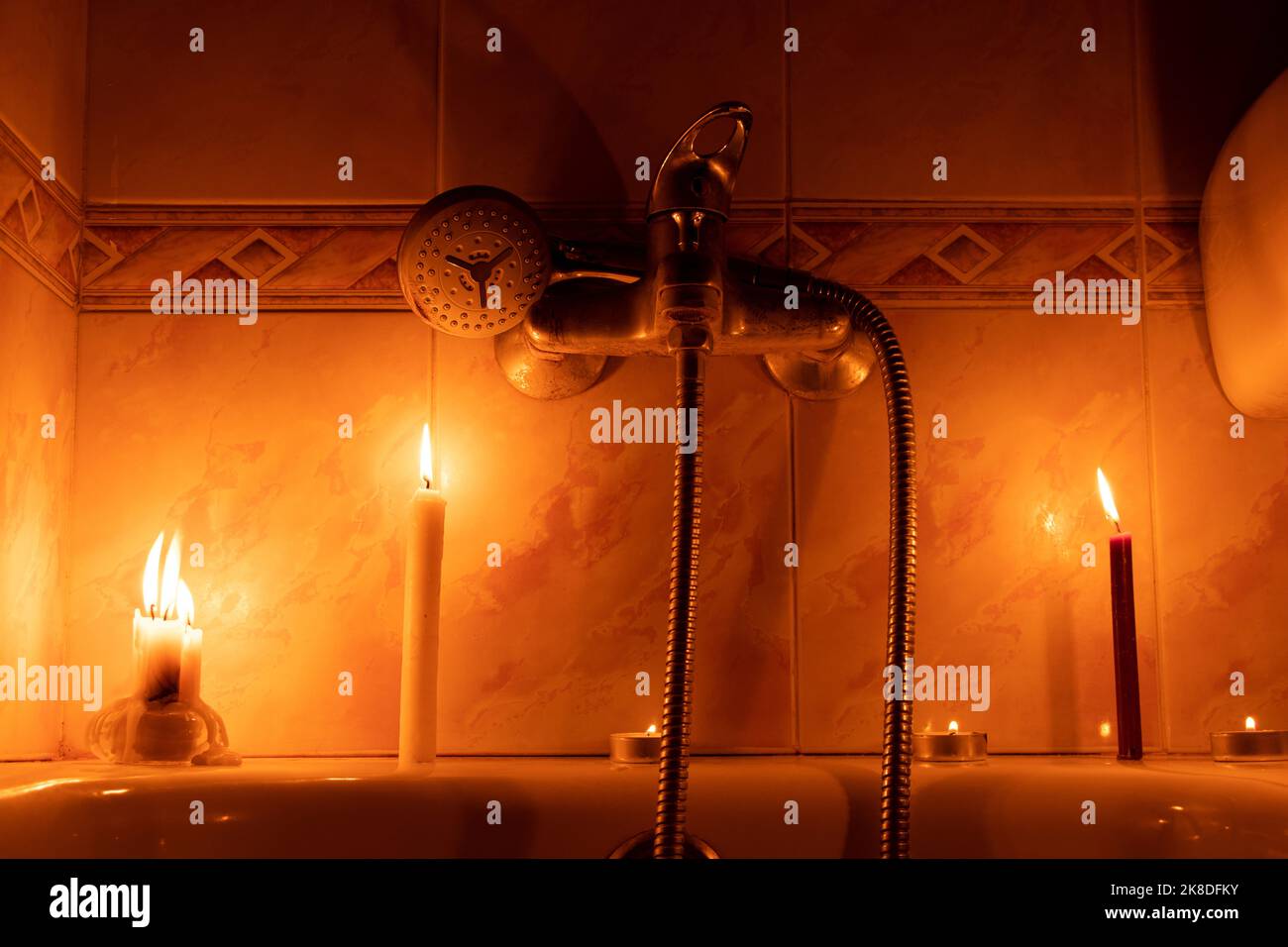 Candles in the bathroom in a dark apartment in Ukraine, Ukraine without
