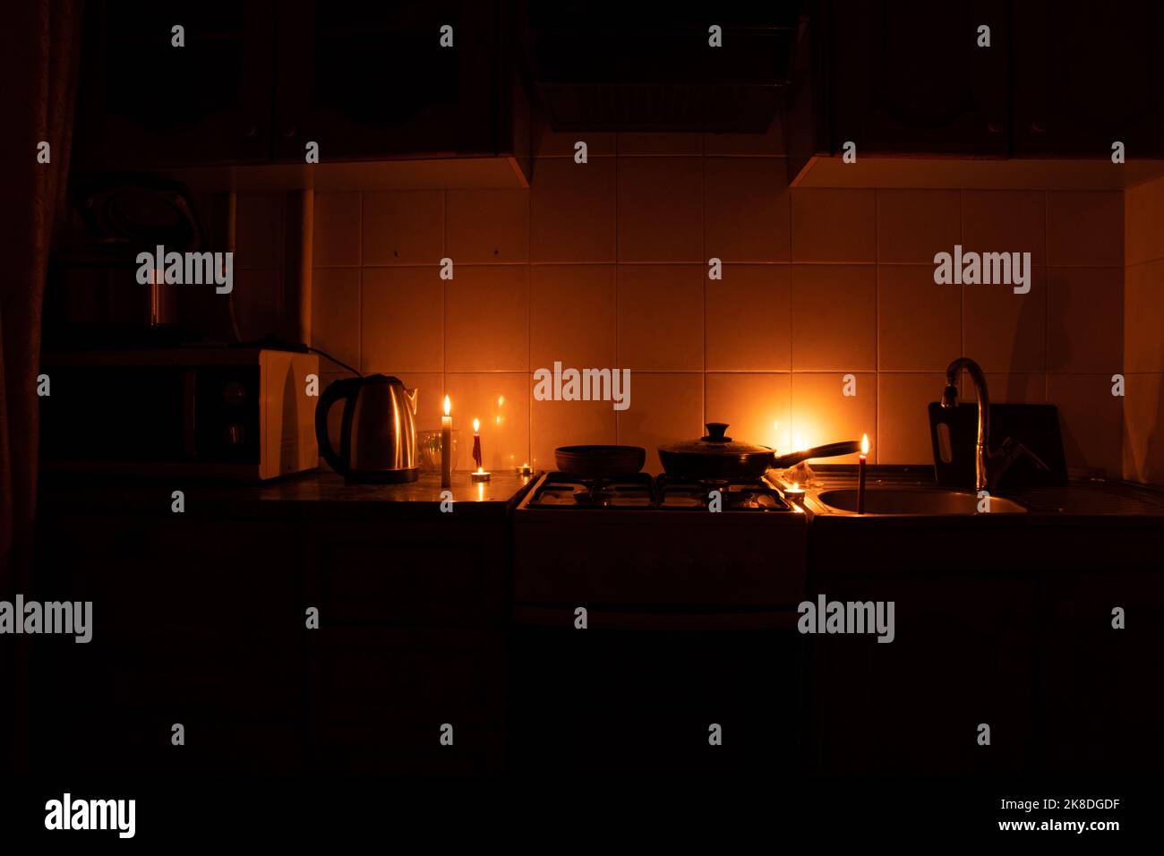 Apartment without electricity, kitchen by candlelight, Ukraine without
