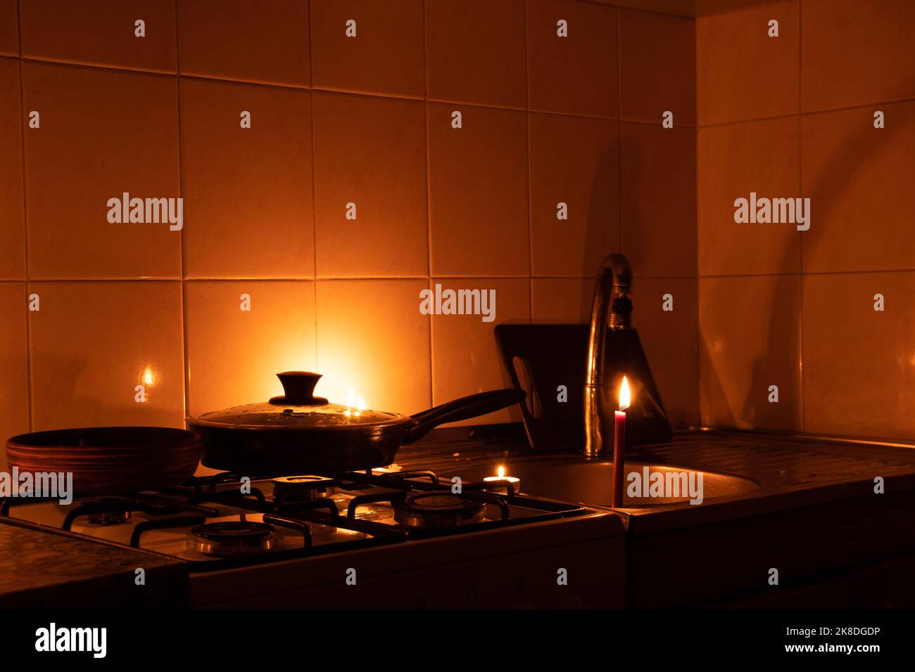 Apartment without electricity, kitchen by candlelight, Ukraine without