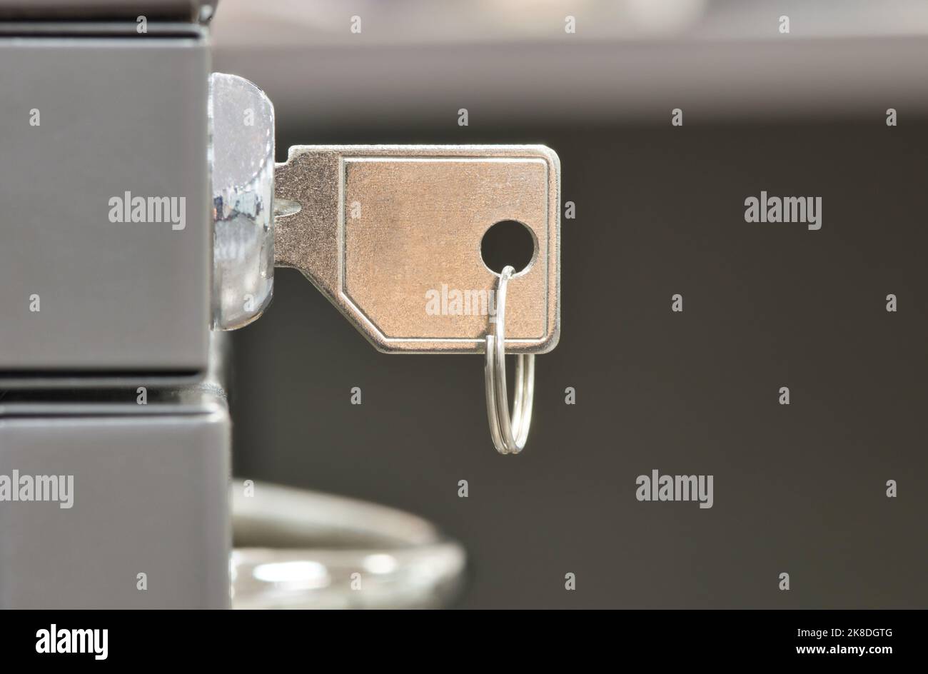Generic key inserted in a filing lock. Side view closeup with