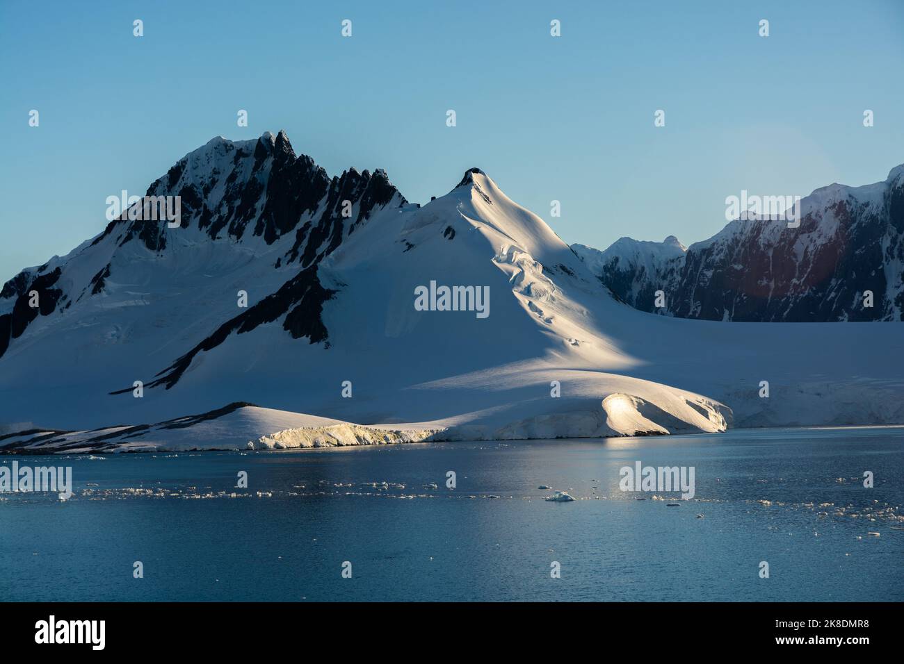 early morning sun on jabet peak (r) and noble peak (l) on wiencke