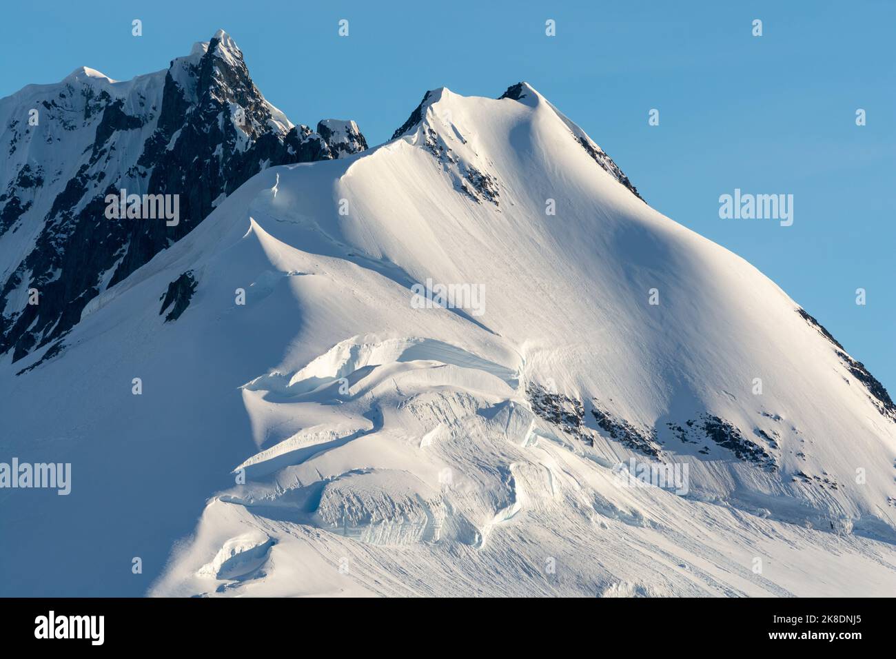 early morning sun on jabet peak (r) and noble peak (l) on wiencke
