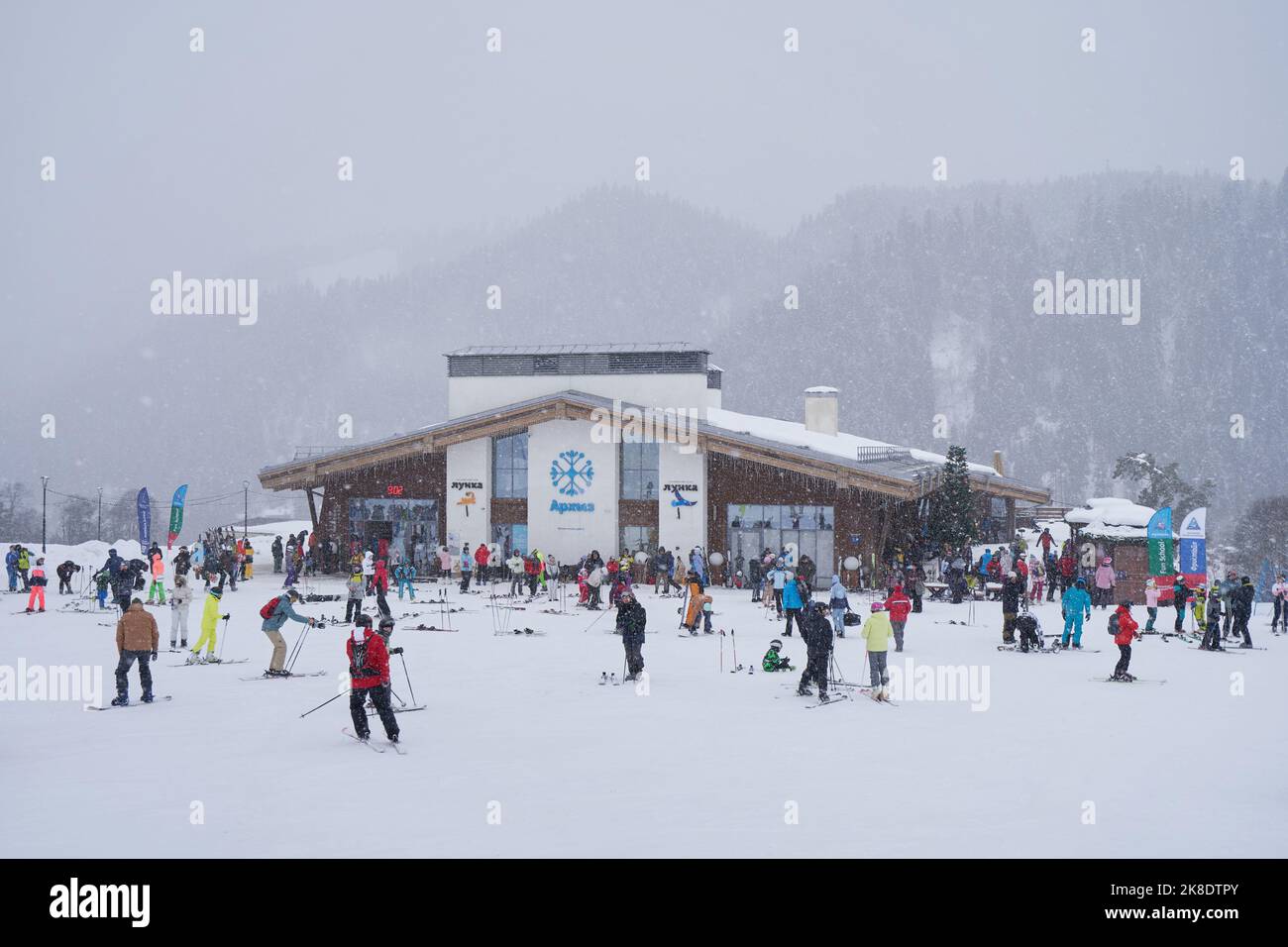 Crowd of people snowboarders and skiers in ski resort Stock Photo