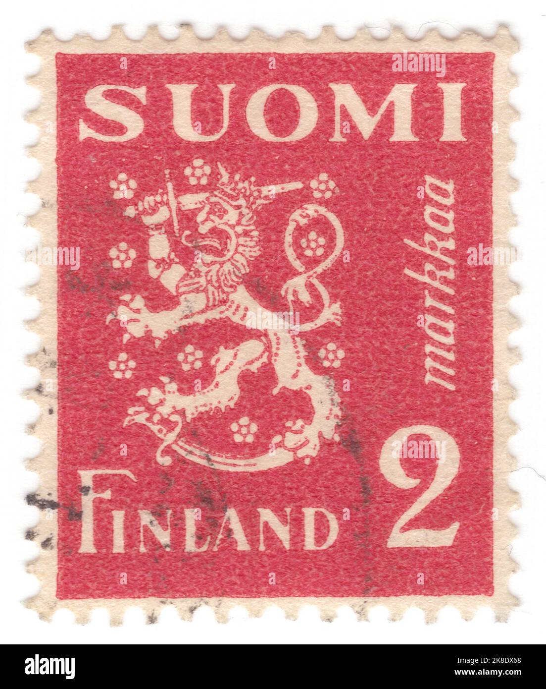 FINLAND - 1936: An 2 marka carmine postage stamp depicting Finnish heraldic symbols: Crowned lion, sword, saber and stylized flowers Stock Photo