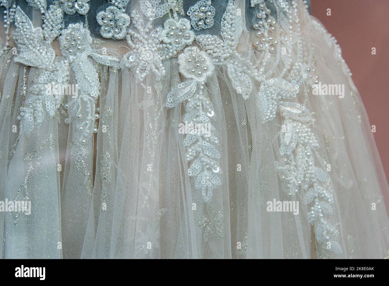 Beautiful bridal dress on hangers. Embroidery with beads. Wedding dress ...