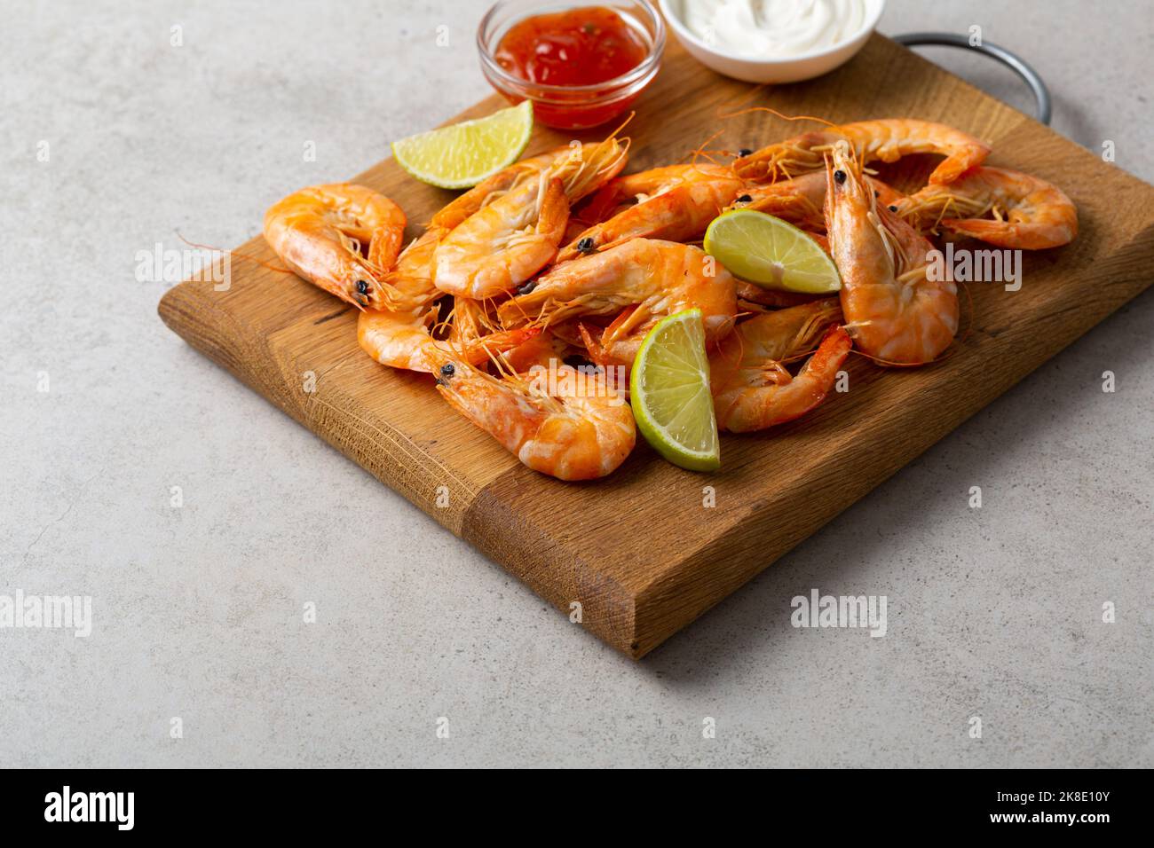 Close up of roasted prawn food on wooden seafood lime sauce Stock Photo