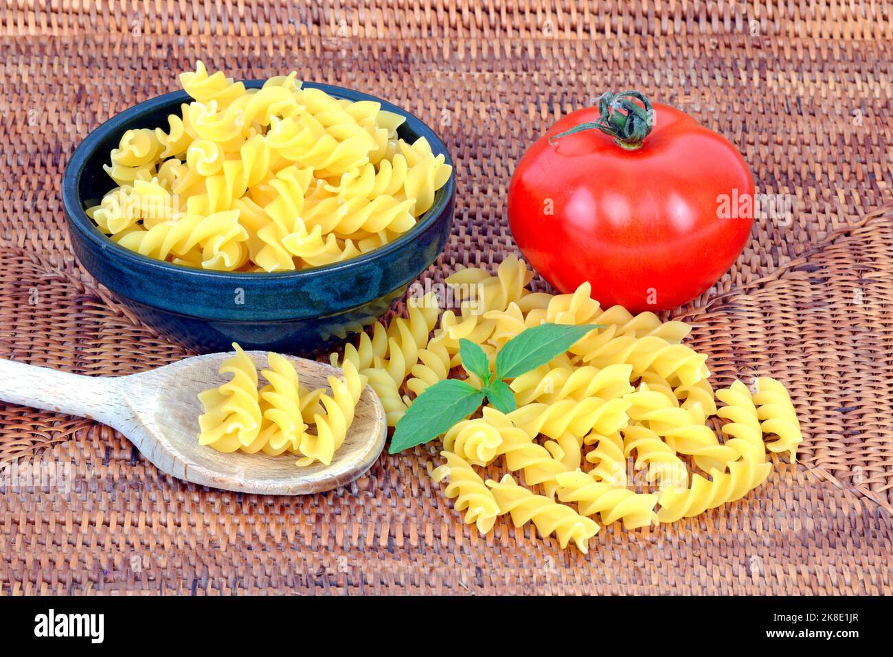 Italian pasta, fusilli, pasta, noodles, tomato, basil Stock Photo