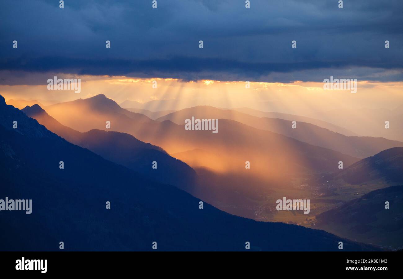Beams of light at sunset on Puster Valley. Mountain profiles. Italian Alps. Europe. Stock Photo