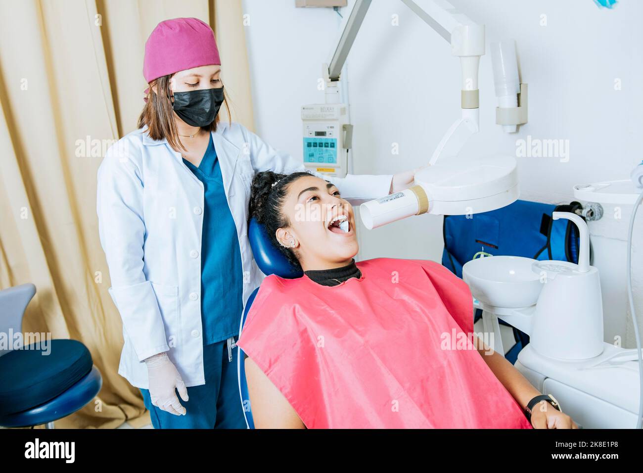 Dentist performing intraoral dental xray on a patient, Dentist