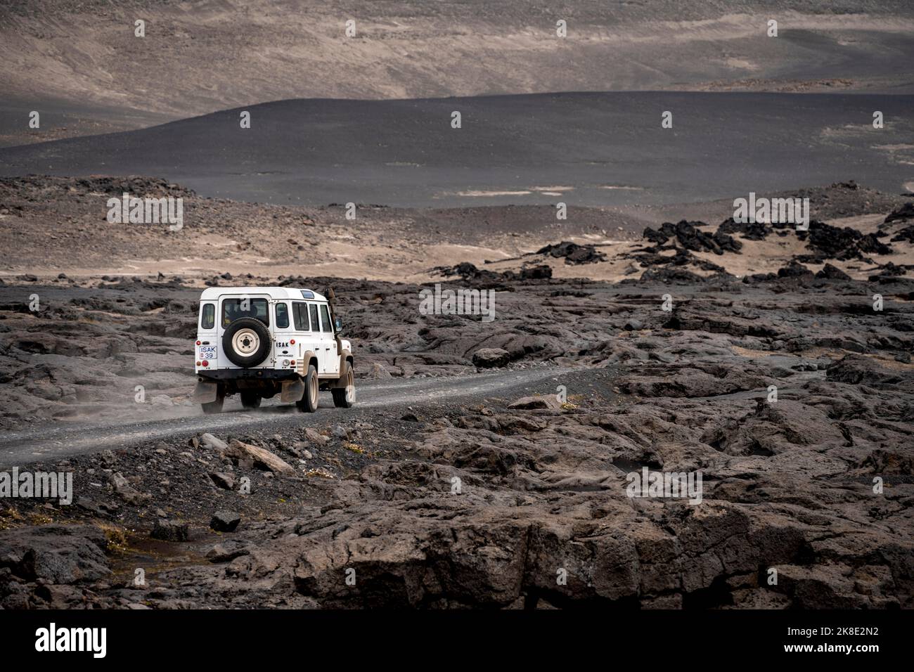 Volcanic Explore Rover White Land Rover on a dirt road, volcanic landscape, barren landscape ...