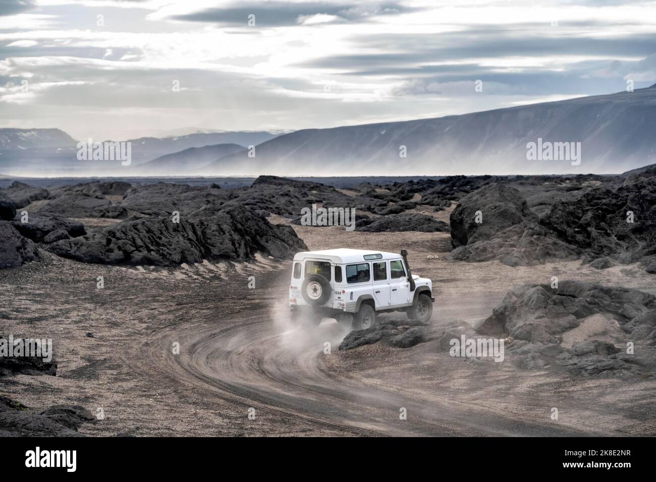 Volcanic Explore Rover White Land Rover on a dirt road, volcanic landscape, barren landscape ...