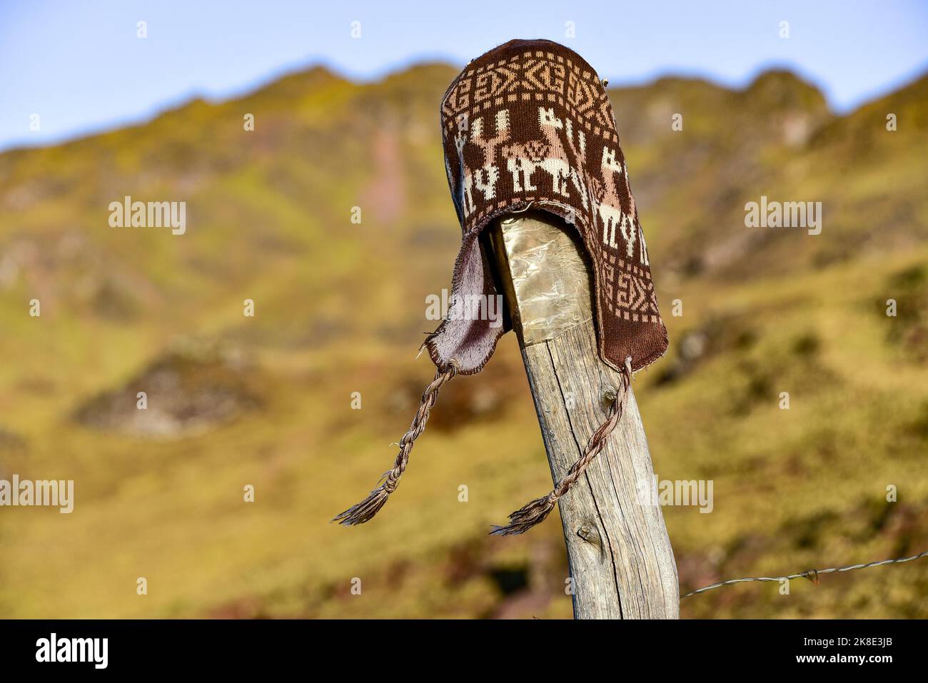 Chullo, traditional Peruvian cap fluttering in the wind on a post, Andes, near Cusco, Peru, South America Stock Photo