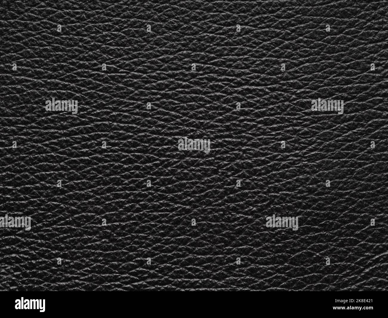 Luxury black leather texture sample. Background with copy space, top view. Genuine leather pattern in dark tone. Faux eco leather. Backdrop textured Stock Photo