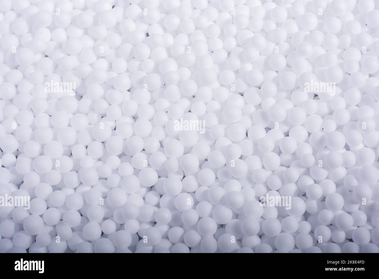 White little polystyrene foam balls as background Stock Photo - Alamy