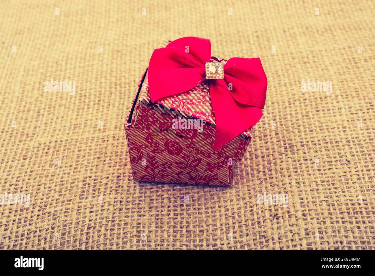 Gift box with red ribbon made of cardboard Stock Photo - Alamy