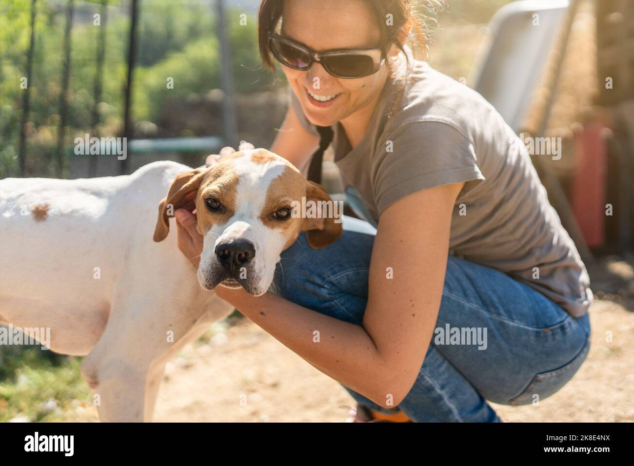 Portrait of a woman petting a dog Stock Photo