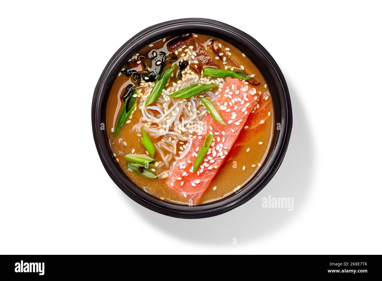 Japanese creamy miso soup with salmon, rice noodles, seaweeds, shiitake mushrooms, sesame and green onion Stock Photo