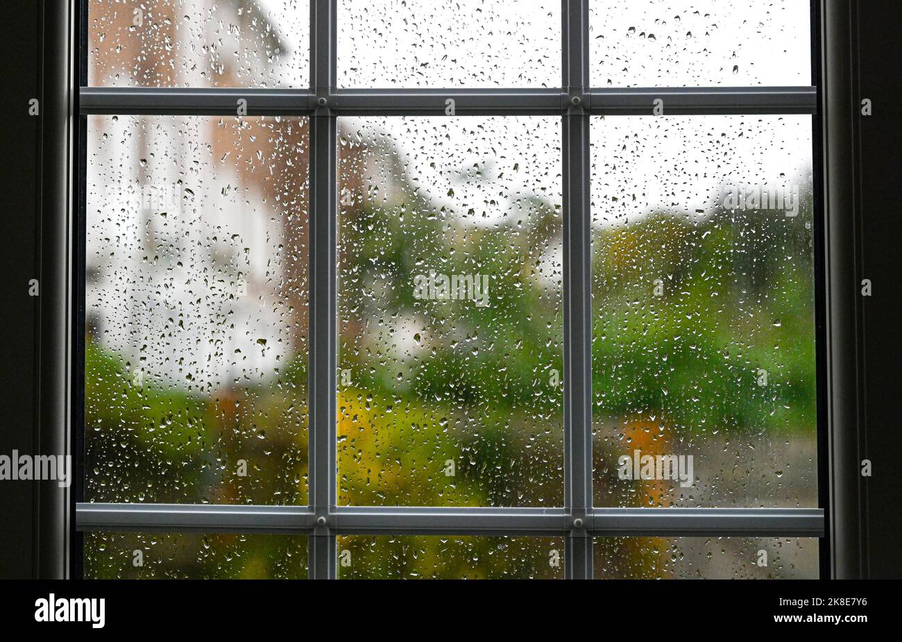 Raindrops on a glass window pane during wet weather England UK Stock Photo