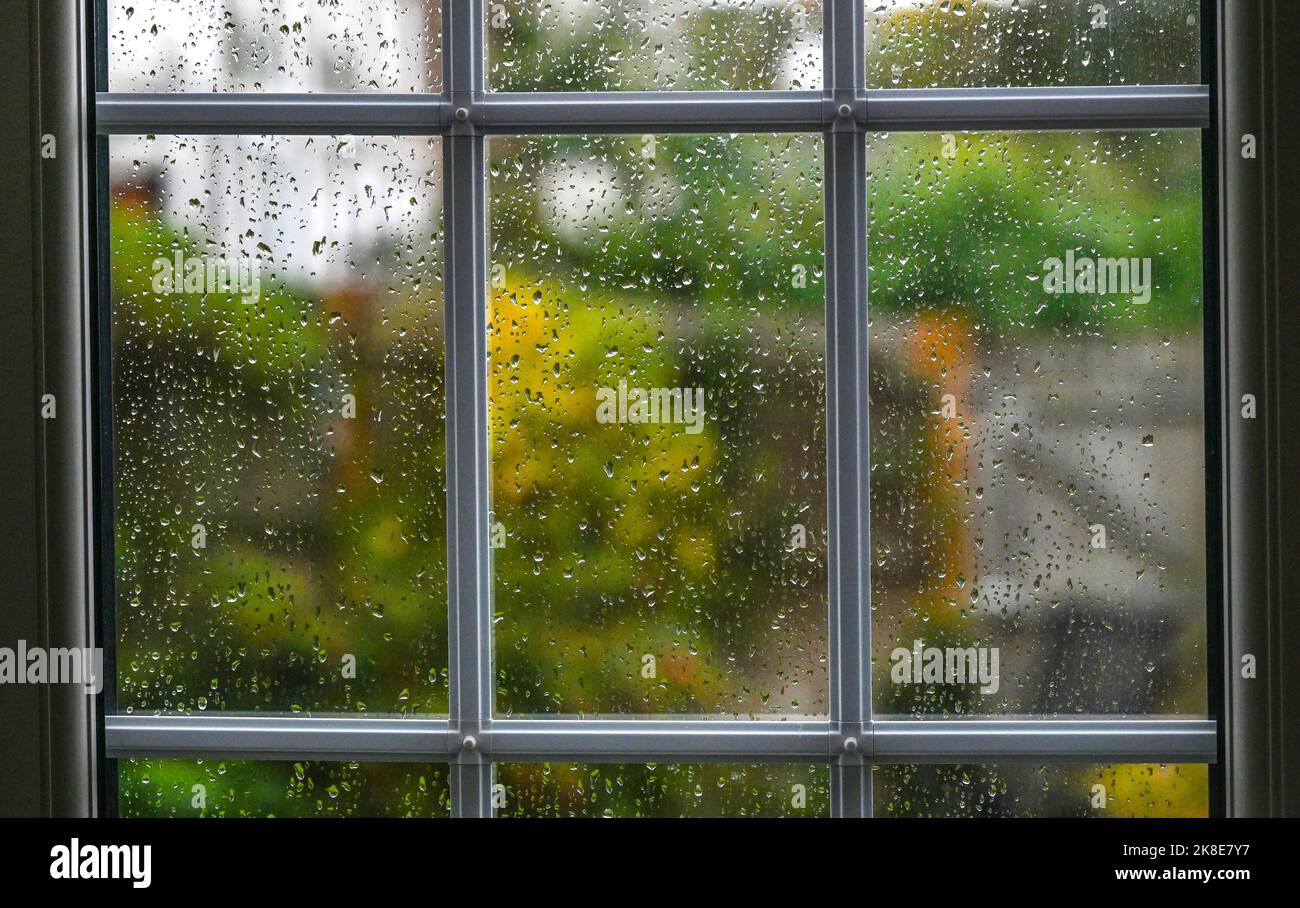 Raindrops on a glass window pane during wet weather England UK Stock Photo