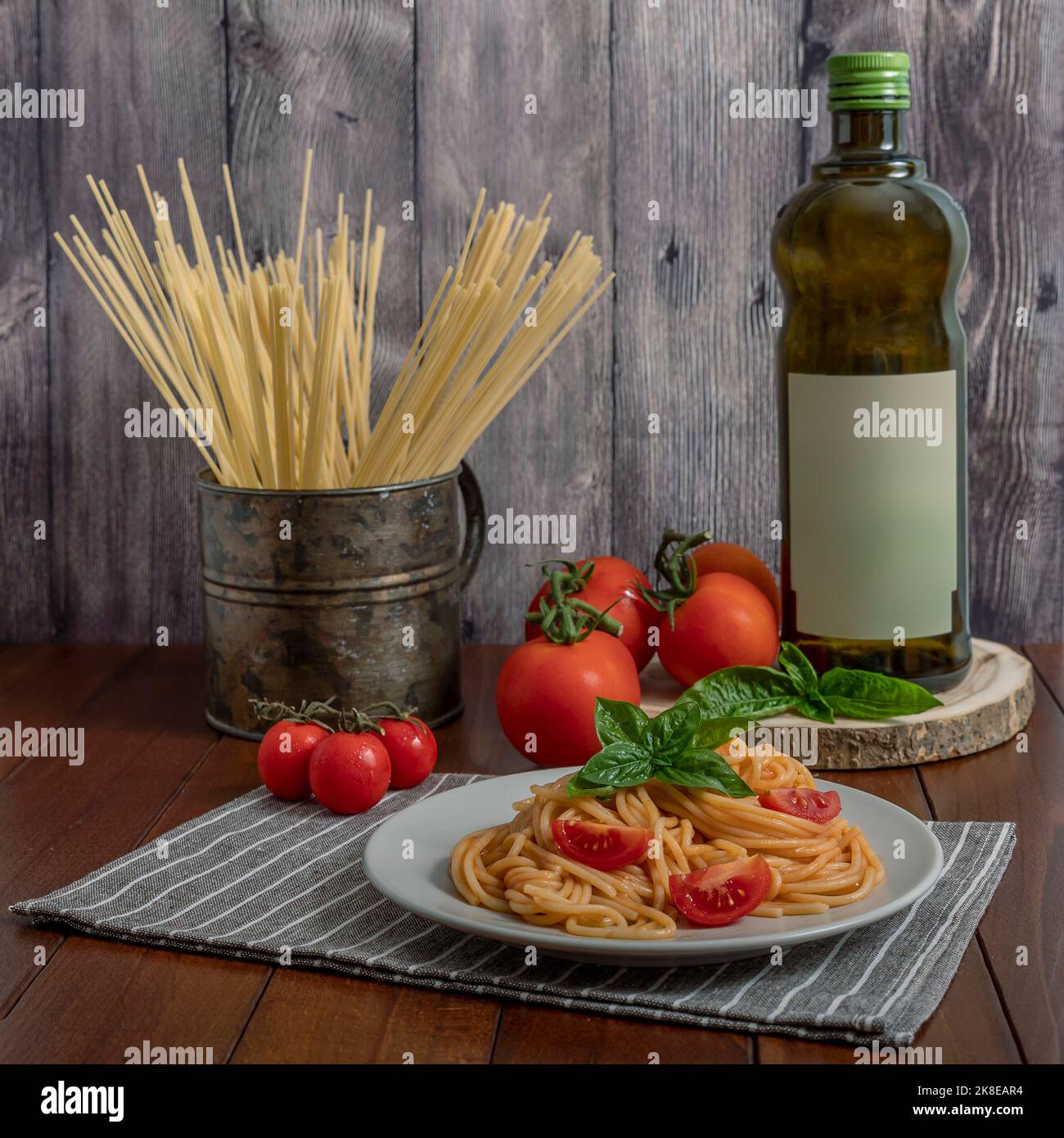 A delicious plate of spaghetti with tomato, basil and extra virgin olive oil, a typical Italian recipe Stock Photo