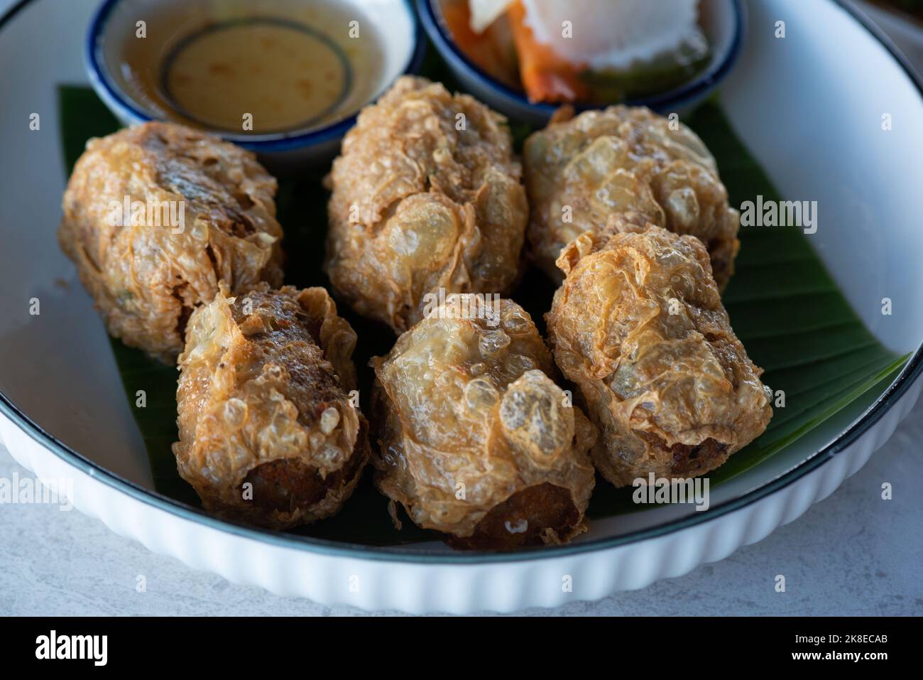 A plate of delicious deep fried crab meat roll on the table. Stock Photo