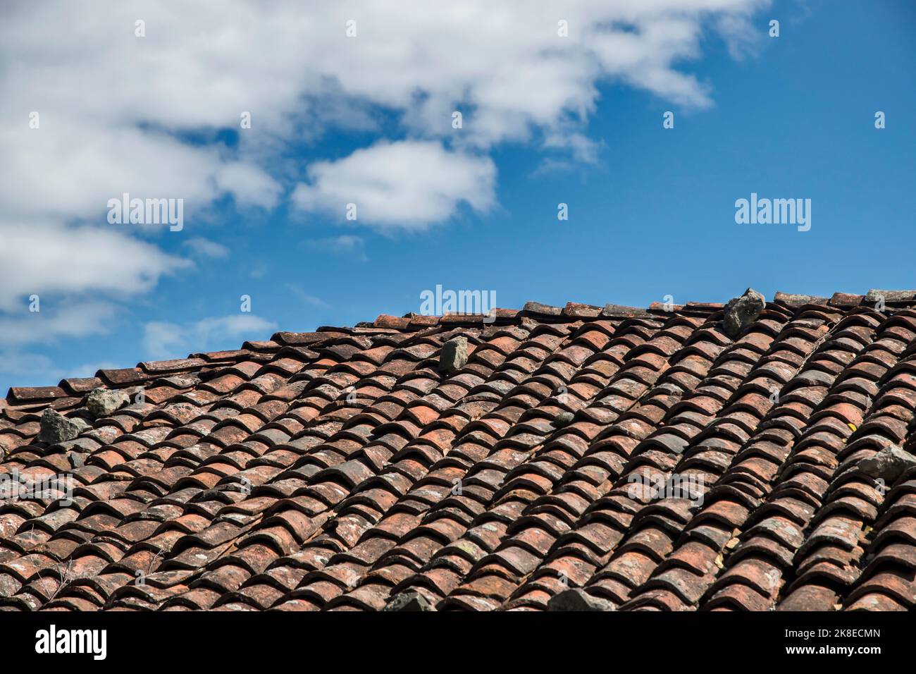Roof of old country house from weathered aged clay tiles closeup Stock Photo