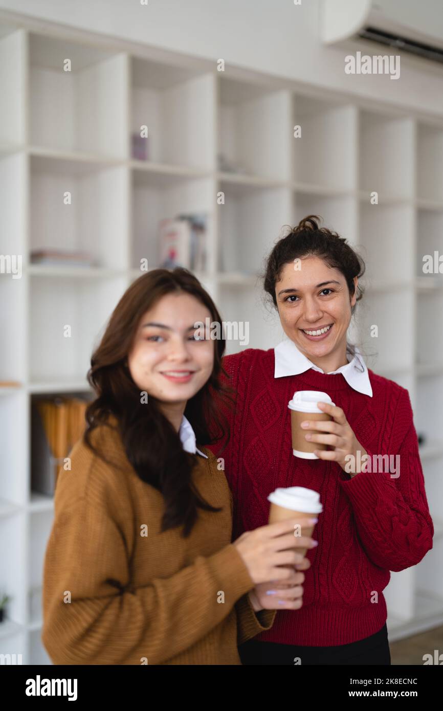 Portrait diverse friendly coworkers coffee break talking office