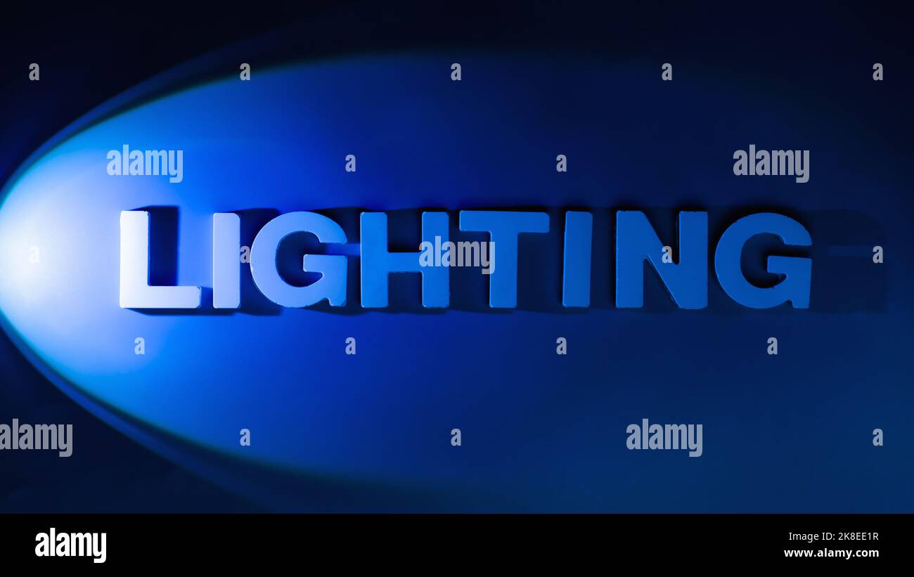 Lighting Text in bright spotlight on blue background Stock Photo Alamy