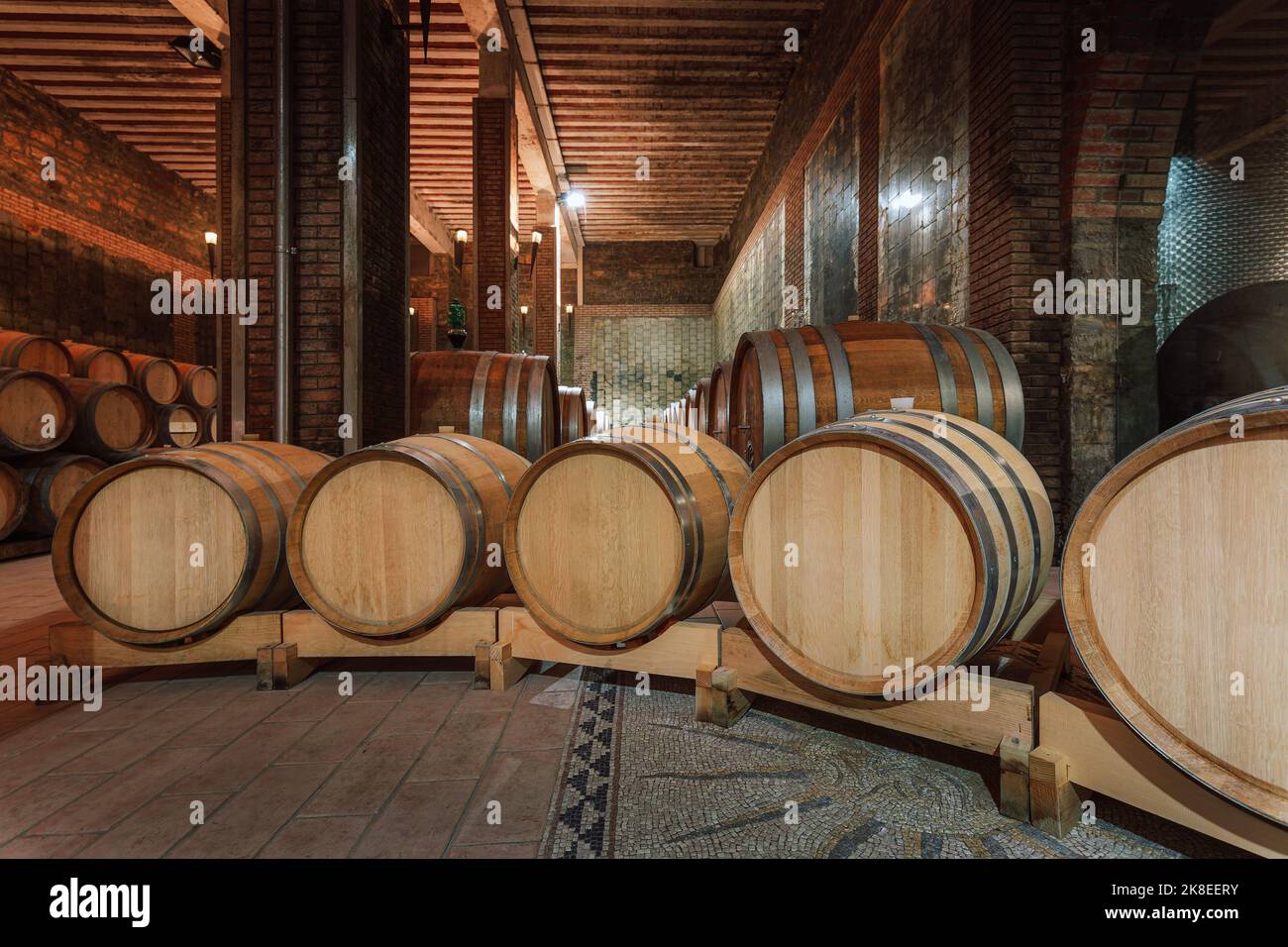 Wine cellar, underground cool dry stone walls storage room, with authentic old oak barrels and