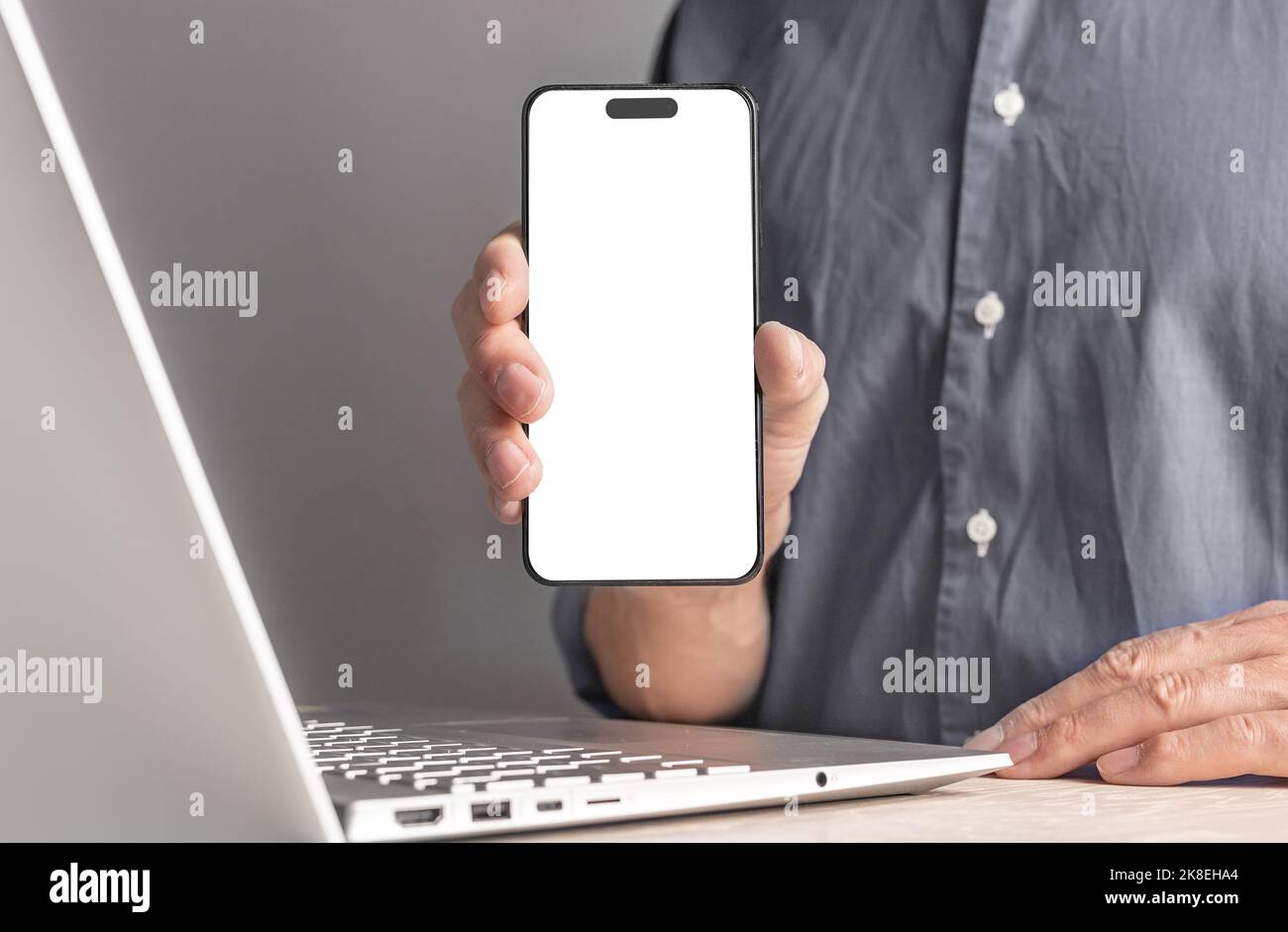 Minsk, Belarus October 23 2022 - Businessman hand holding iphone 14 smartphone mockup, screen template. High quality photo Stock Photo