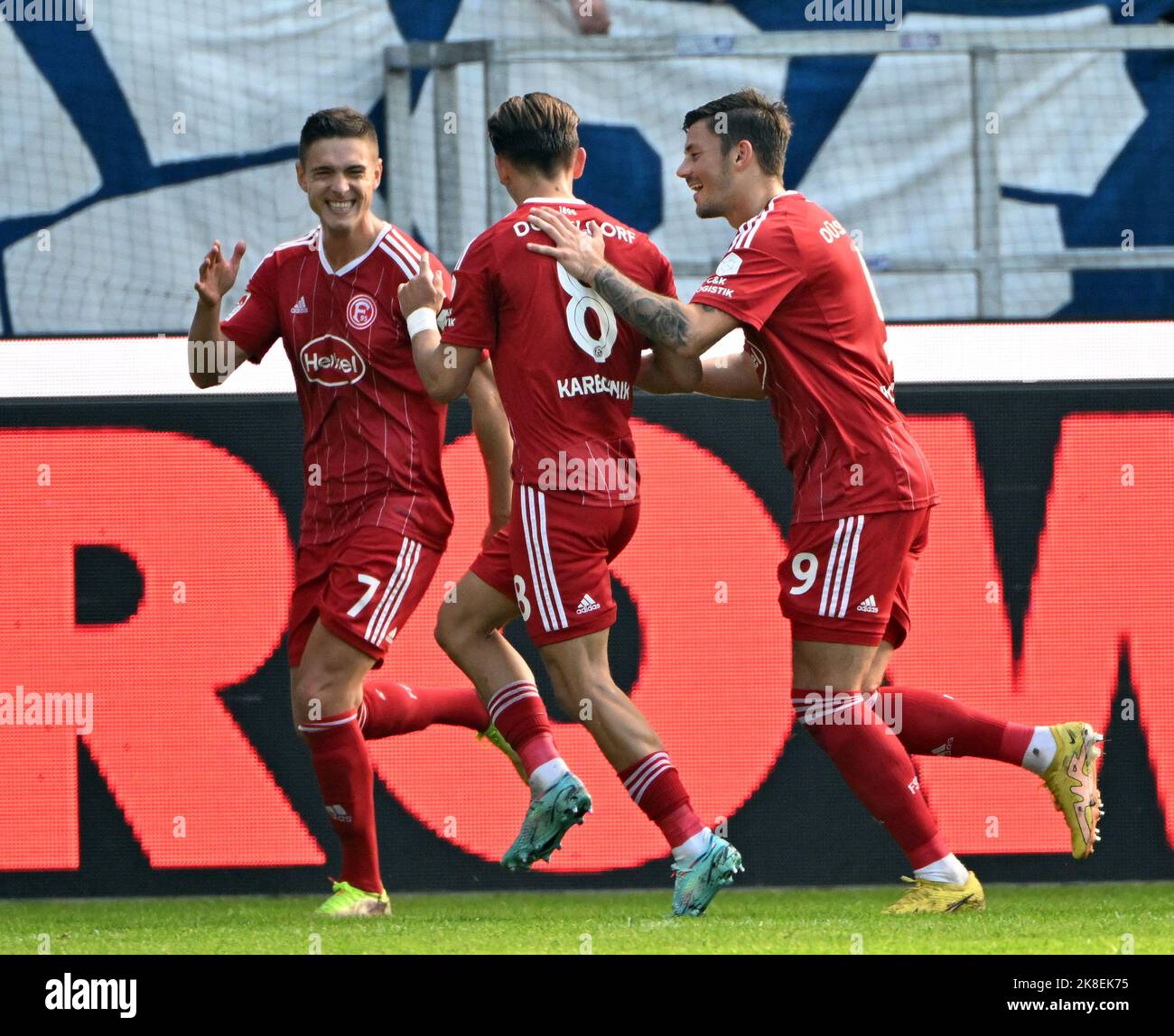 Karlsruhe, Germany. 23rd Oct, 2022. Soccer, 2. Bundesliga, Karlsruher SC - Fortuna Düsseldorf, Matchday 13, at BBBank Wildpark. Düsseldorf players (l-r) Kristoffer Peterson, Michael Karbownik and Dawid Kownacki celebrate the 0:2 goal by Kristoffer Peterson. Credit: Uli Deck/dpa - IMPORTANT NOTE: In accordance with the requirements of the DFL Deutsche Fußball Liga and the DFB Deutscher Fußball-Bund, it is prohibited to use or have used photographs taken in the stadium and/or of the match in the form of sequence pictures and/or video-like photo series./dpa/Alamy Live News Stock Photo